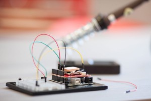 Partially assembled Sparkfun Inventor's Kit, with an Arduino board, breadboard, and soldering iron